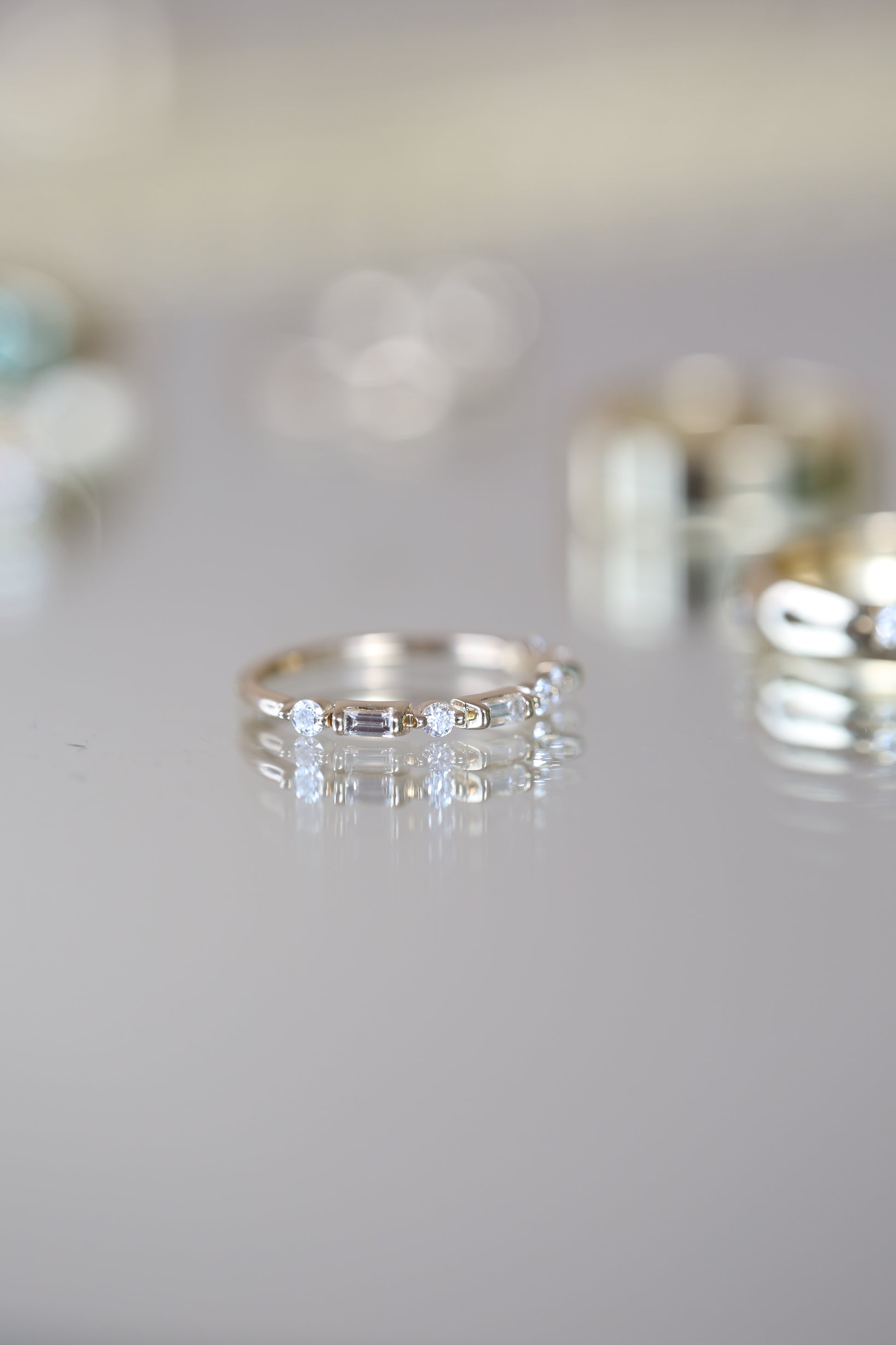 Editorial photo of Joelle Ring styled on reflective glass.